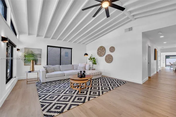a living room with a couch and a table with wooden floor