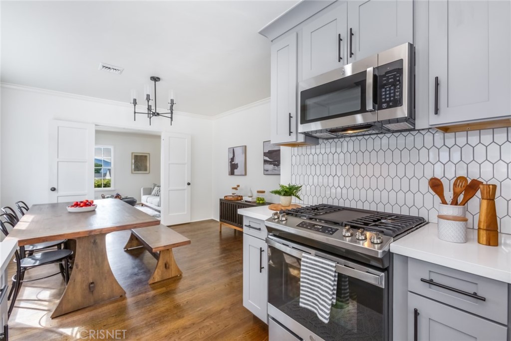 2091 West Mountain Street Glendale, CA 91201 - Photo 18 of 60 a kitchen with stainless steel appliances kitchen island a stove and a microwave
