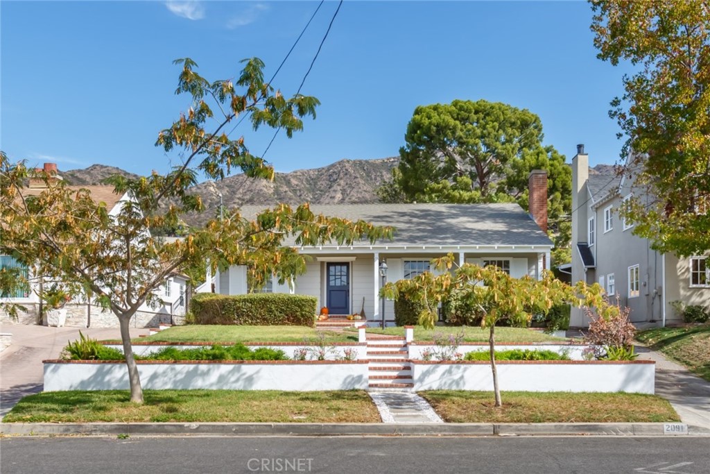 2091 West Mountain Street Glendale, CA 91201 - Photo 3 of 60 a front view of a house with a garden