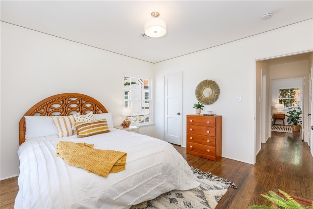 2091 West Mountain Street Glendale, CA 91201 - Photo 33 of 60 a bedroom with a bed and dresser with wooden floor