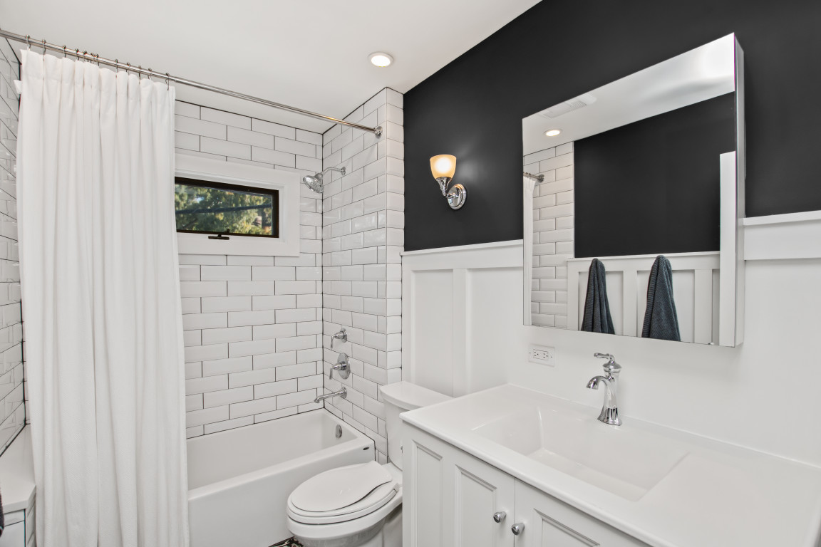 606 5th Street, Unit 606 Wilmette, IL 60091 - Photo 13 of 14 a bathroom with a sink a toilet and shower