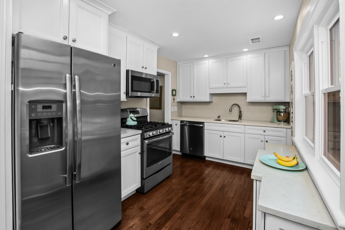 606 5th Street, Unit 606 Wilmette, IL 60091 - Photo 5 of 14 a kitchen with a refrigerator a sink and wooden floor
