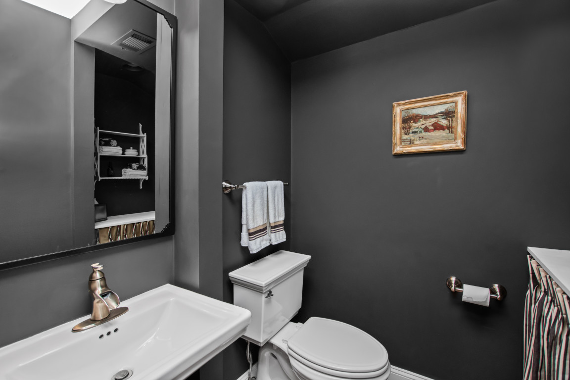 606 5th Street, Unit 606 Wilmette, IL 60091 - Photo 8 of 14 a bathroom with a toilet sink and mirror