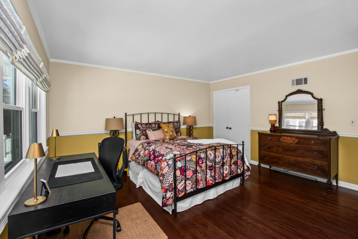 606 5th Street, Unit 606 Wilmette, IL 60091 - Photo 10 of 14 a bedroom with a bed and a dresser with wooden floor