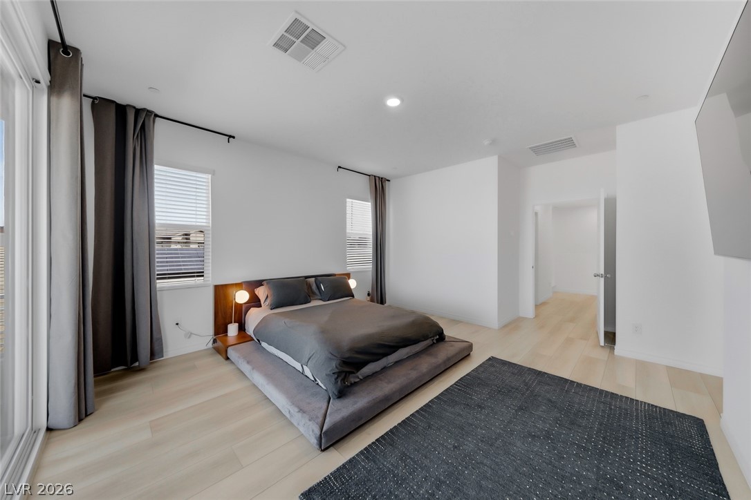 290 Rusty Ridge Lane Henderson, NV 89015 - Photo 13 of 61 Primary bedroom w/luxury vinly plank floors, recessed lights, balcony w/strip & mountain views