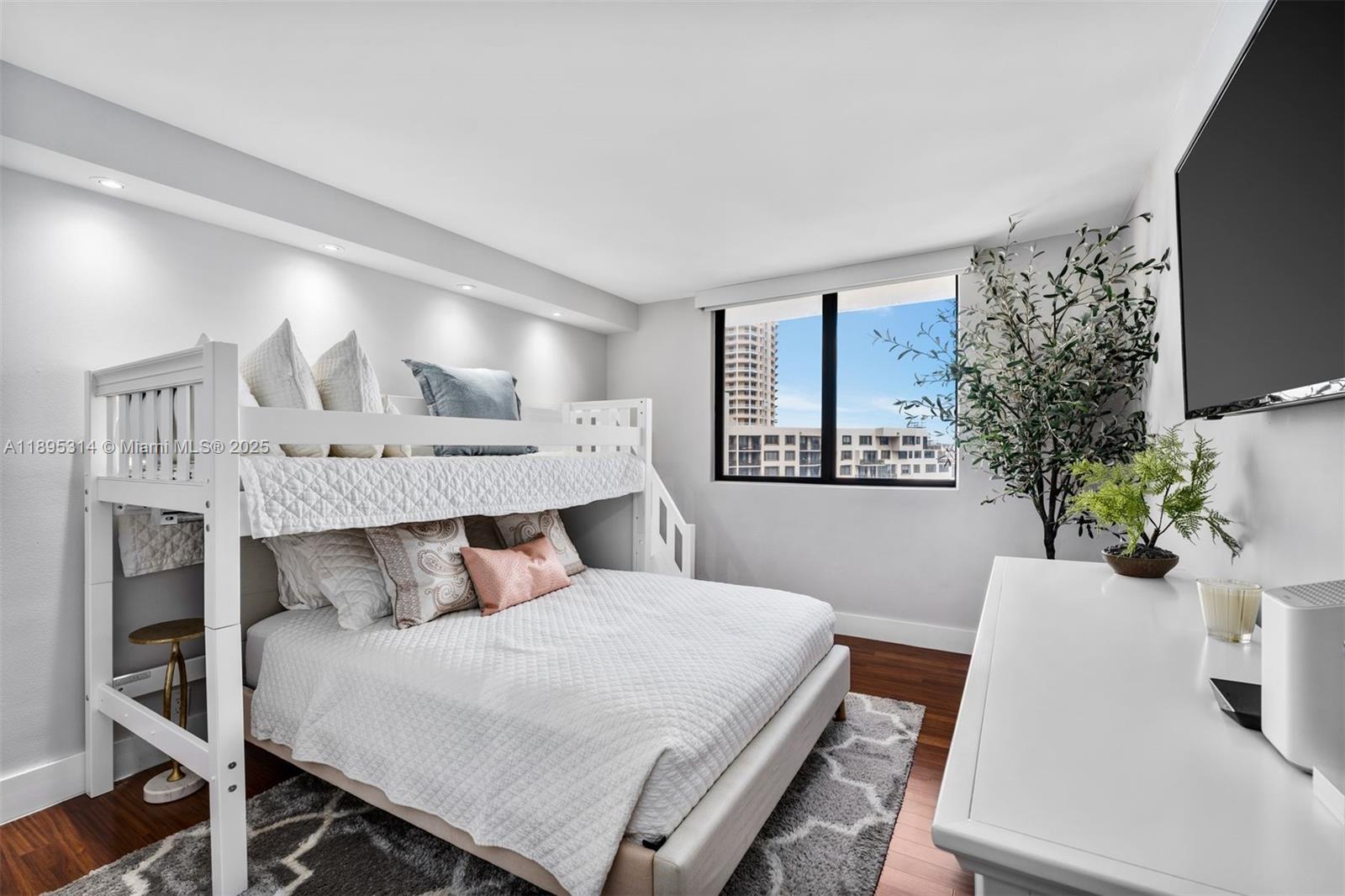 520 Brickell Key Drive, Unit A1716 Miami, FL 33131 - Photo 14 of 29 a bedroom with a bed a potted plant and a window