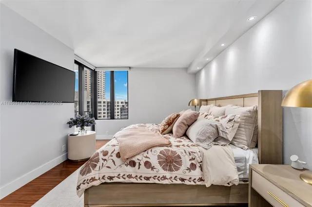 a bedroom with a bed and a flat screen tv