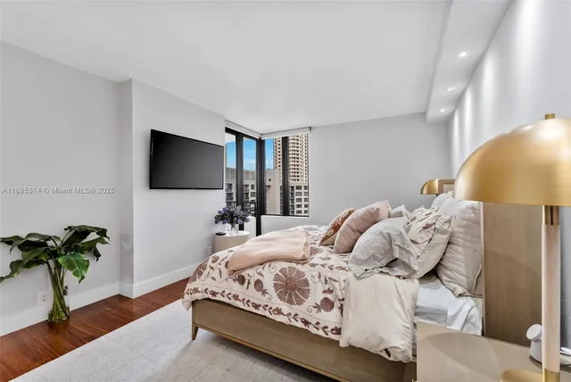 a bedroom with a bed and a potted plant