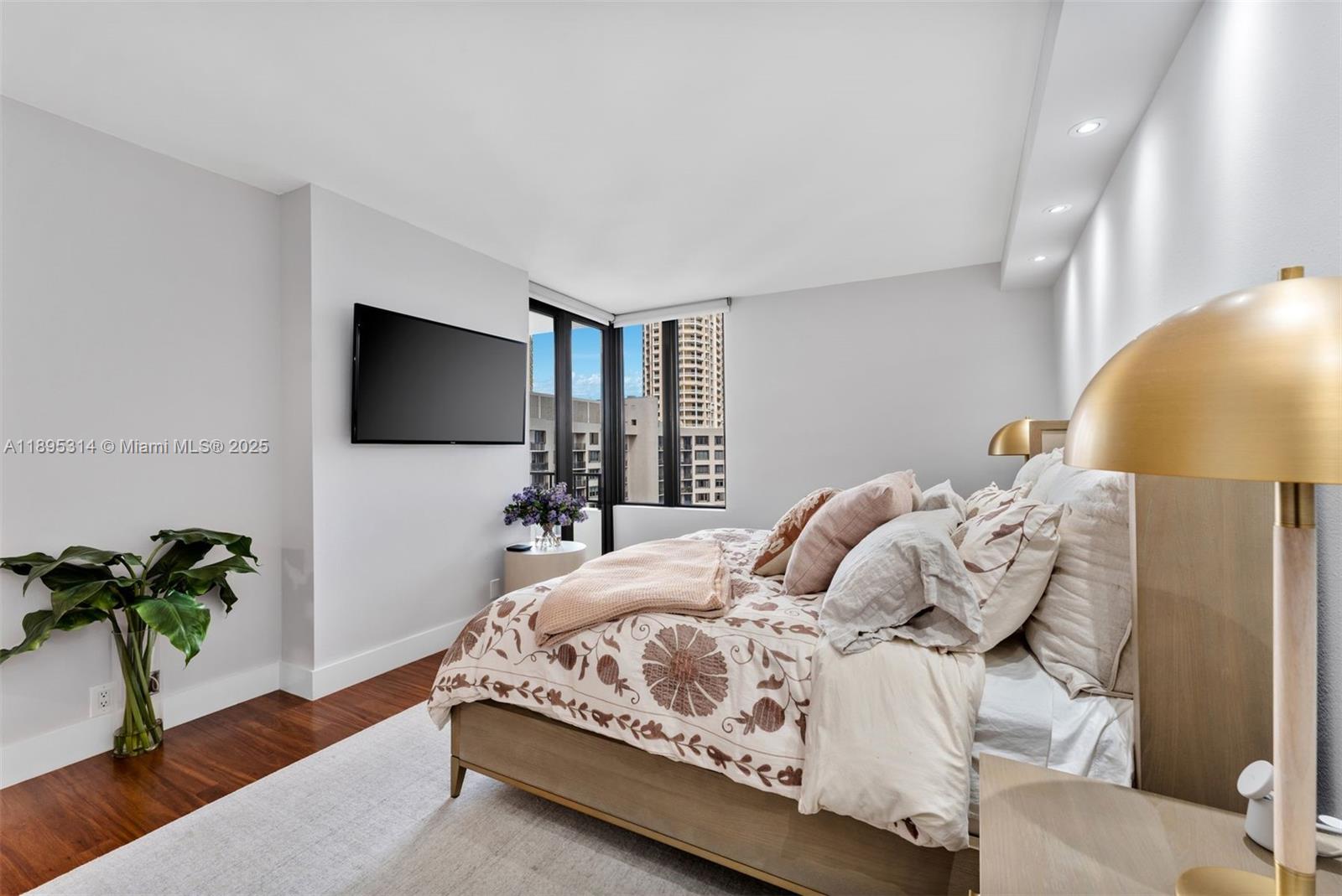 520 Brickell Key Drive, Unit A1716 Miami, FL 33131 - Photo 19 of 29 a bedroom with a bed and a potted plant