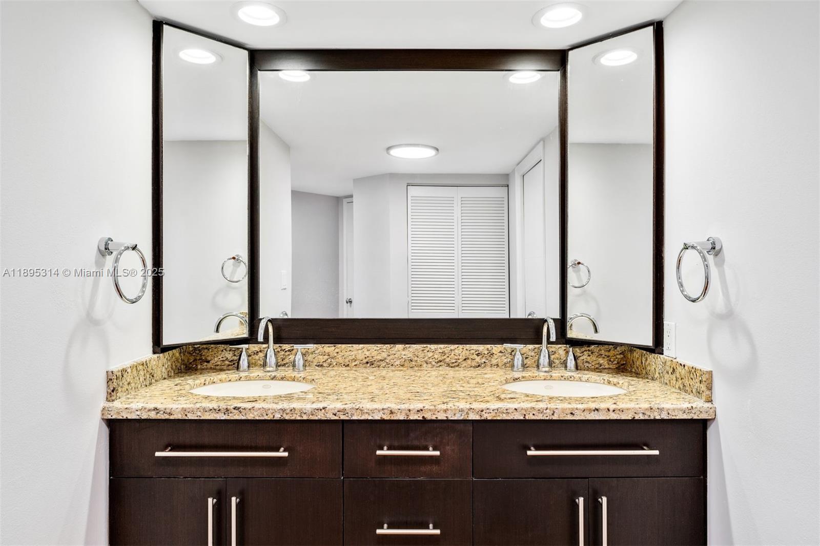 520 Brickell Key Drive, Unit A1716 Miami, FL 33131 - Photo 21 of 29 a bathroom with a granite countertop sink and a mirror