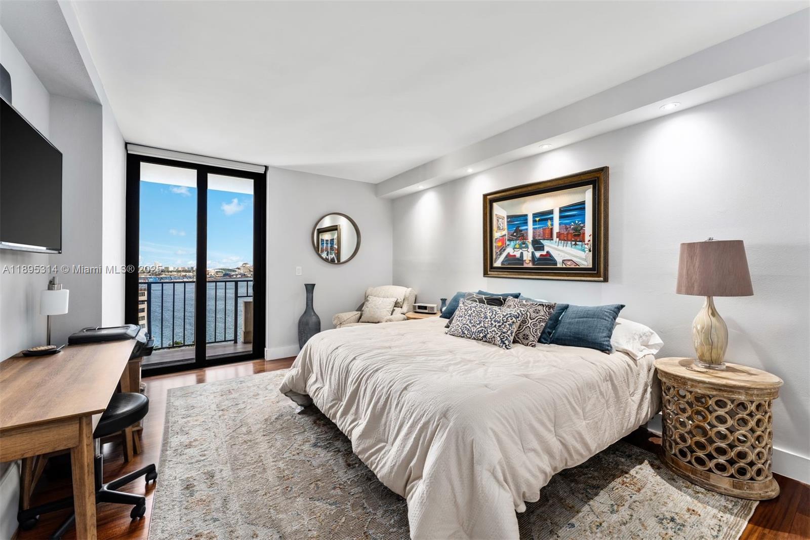 520 Brickell Key Drive, Unit A1716 Miami, FL 33131 - Photo 22 of 29 a bedroom with a bed and a lamp on table