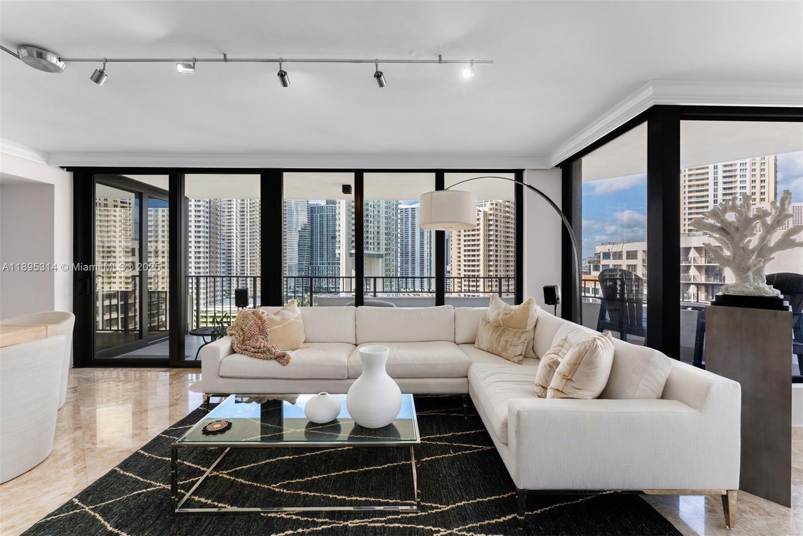 520 Brickell Key Drive, Unit A1716 Miami, FL 33131 - Photo 10 of 29 a living room with furniture and a floor to ceiling window