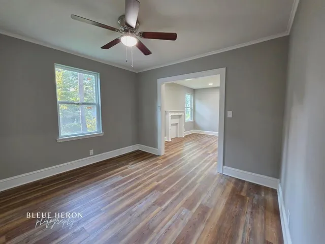 wooden floor in an empty room with a window