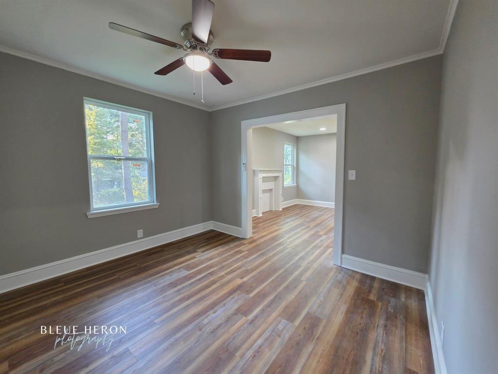 5497 Jefferson Paige Road Shreveport, LA 71119 - Photo 3 of 11 wooden floor in an empty room with a window