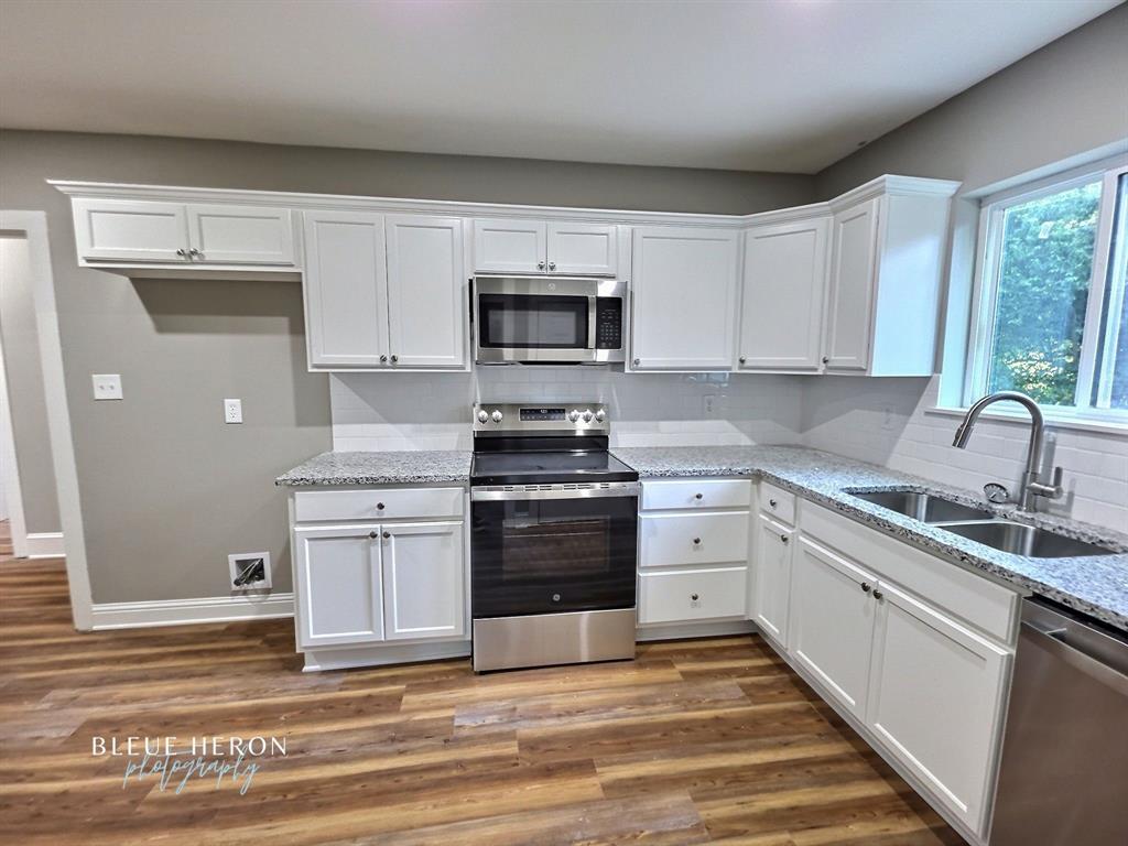 5497 Jefferson Paige Road Shreveport, LA 71119 - Photo 4 of 11 a kitchen with white cabinets and appliances