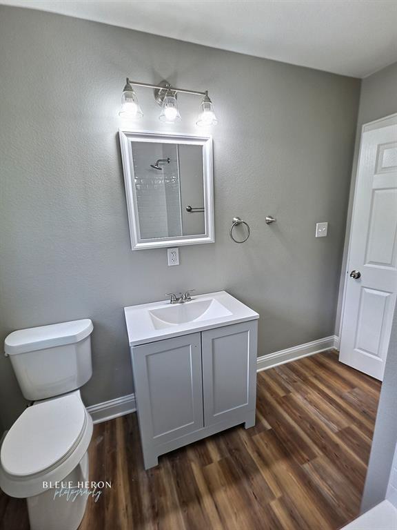 5497 Jefferson Paige Road Shreveport, LA 71119 - Photo 6 of 11 a bathroom with a sink mirror vanity and toilet