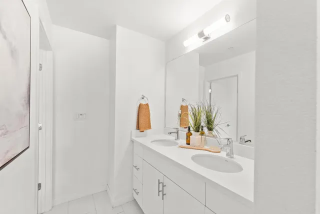 a bathroom with a double vanity sink and a mirror