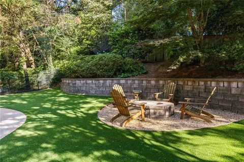a view of a chair and table in the garden