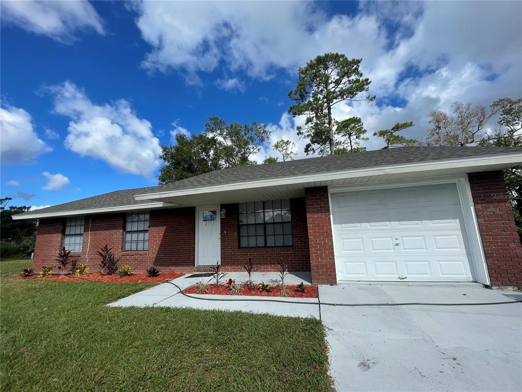 2355 Cypress Road DeLand, FL 32724 - Photo 2 of 14 a front view of a house with garden
