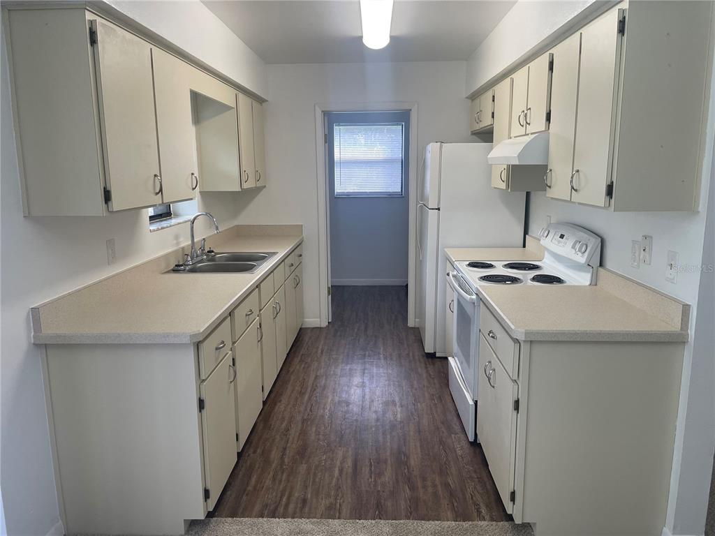 2355 Cypress Road DeLand, FL 32724 - Photo 5 of 14 a kitchen with sink a stove and refrigerator