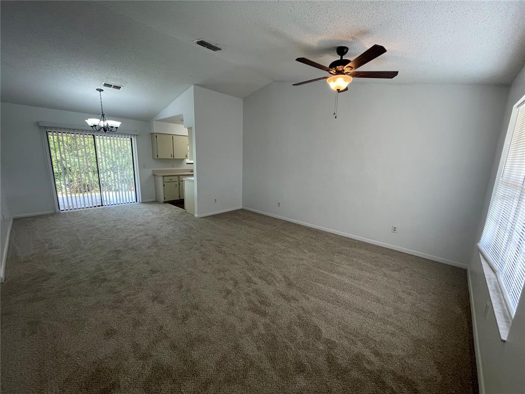 2355 Cypress Road DeLand, FL 32724 - Photo 8 of 14 a view of an empty room with a ceiling fan and window