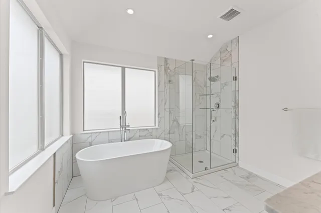 a spacious bathroom with a shower tub and a sink