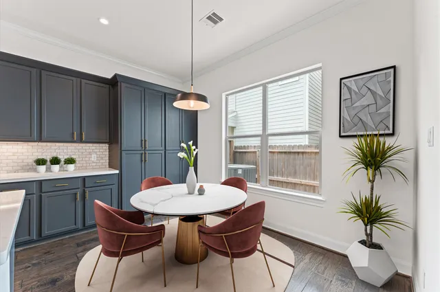 a kitchen with a table and chairs in it