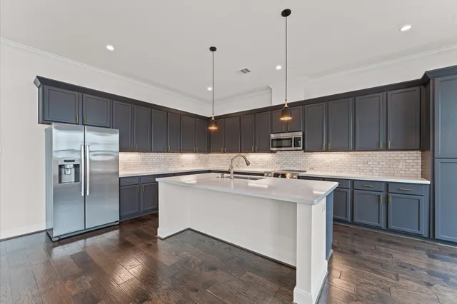 a kitchen with a sink stainless steel appliances and cabinets