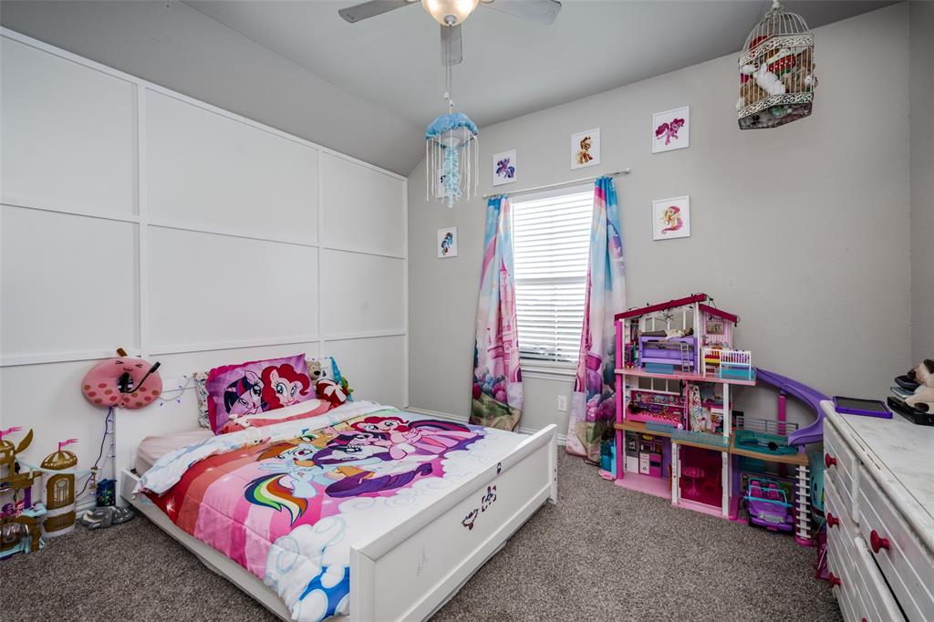 7417 Green Mesa Road Ponder, TX 76259 - Photo 25 of 39 a bedroom with a bed and a chandelier