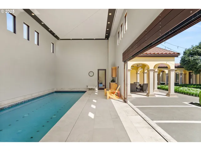 a swimming pool with yard and furniture