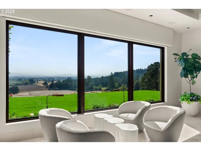 a backyard of a house with a garden and outdoor seating