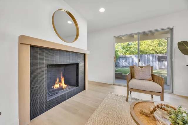 a kitchen with white cabinets appliances and a window