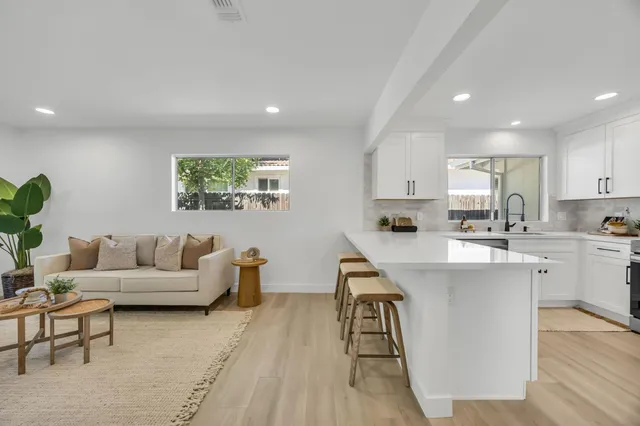 a kitchen with cabinets a sink and a window
