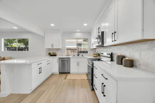 a bedroom with a large bed and a chandelier
