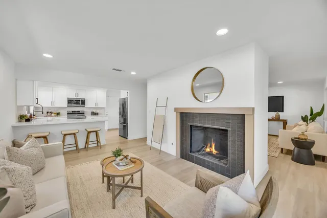 a view of a livingroom with a sink and a mirror