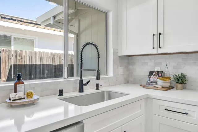 a bathroom with a double vanity sink mirror and shower