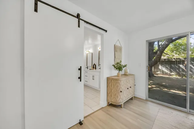 an empty room with wooden floor and window