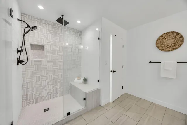 a bathroom with a granite countertop shower mirror and a sink