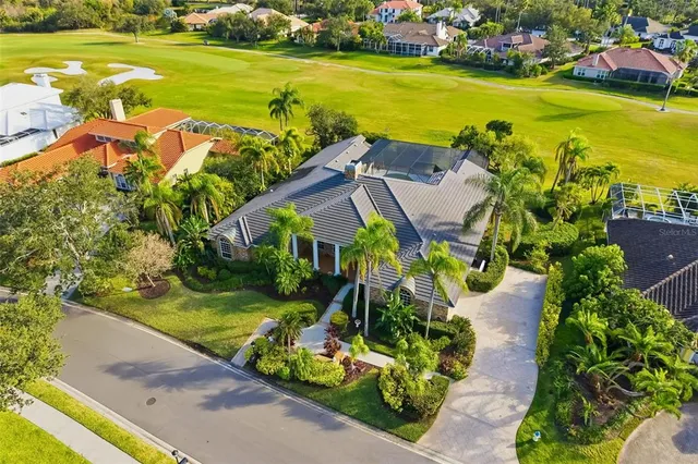 an aerial view of a house with swimming pool and garden