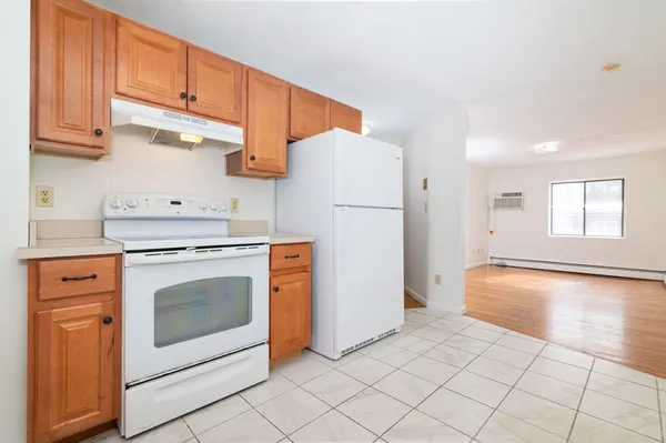 a kitchen with white cabinets and white appliances