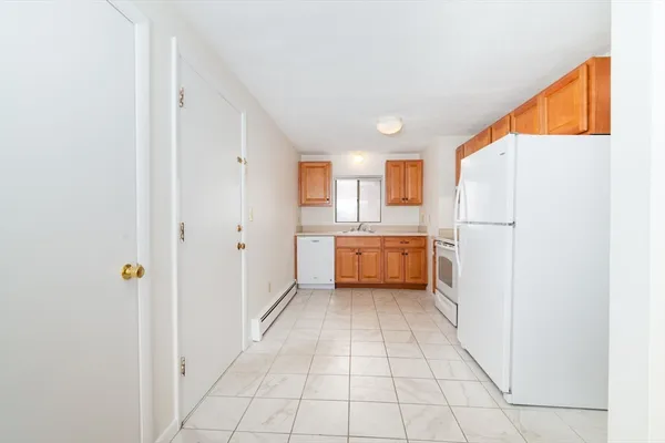 a kitchen with a refrigerator a sink and cabinets