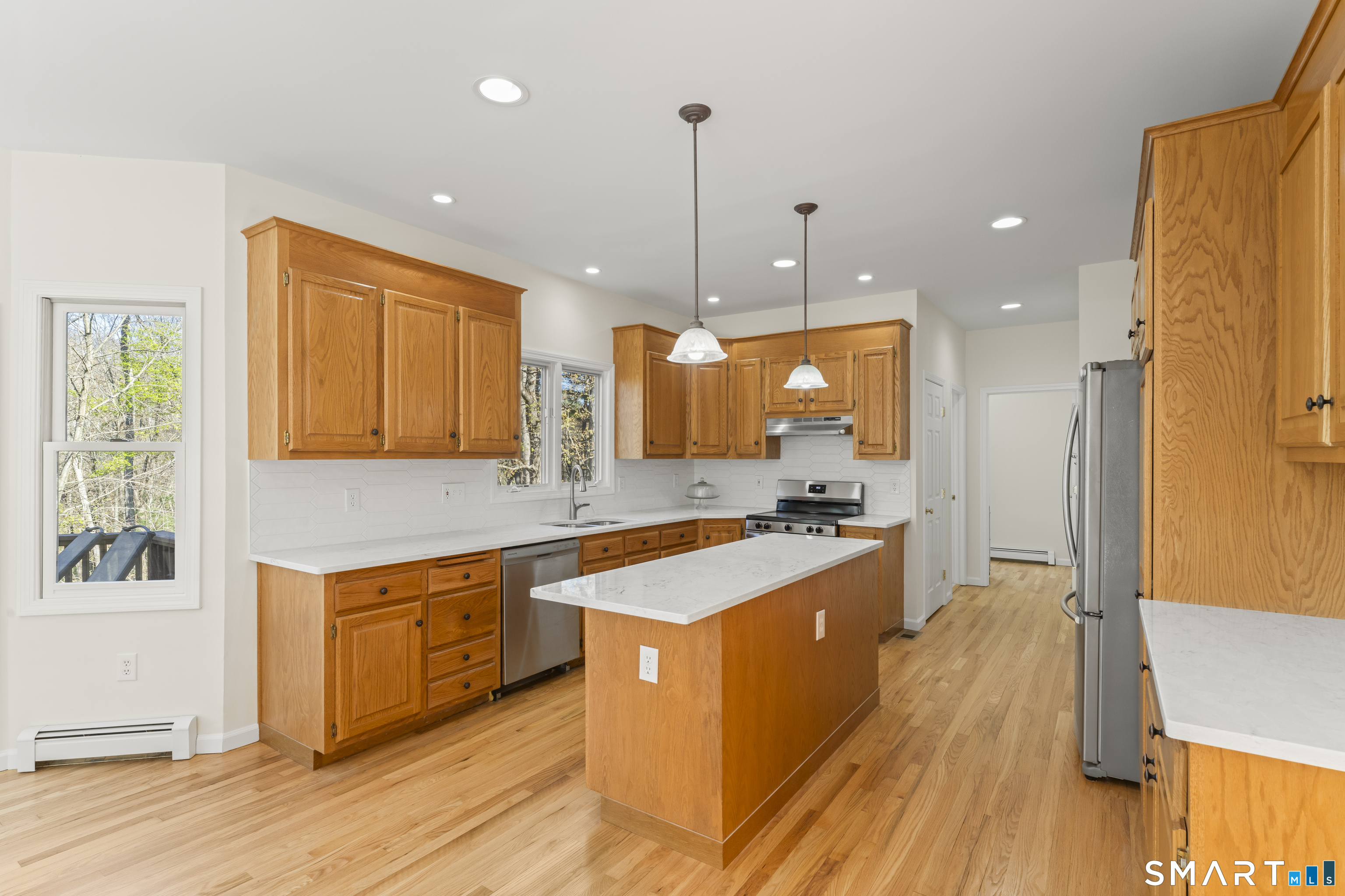 5 Beagle Trail Newtown, CT 06482 - Photo 15 of 40 a large kitchen with kitchen island a stove a sink a refrigerator and a counter space
