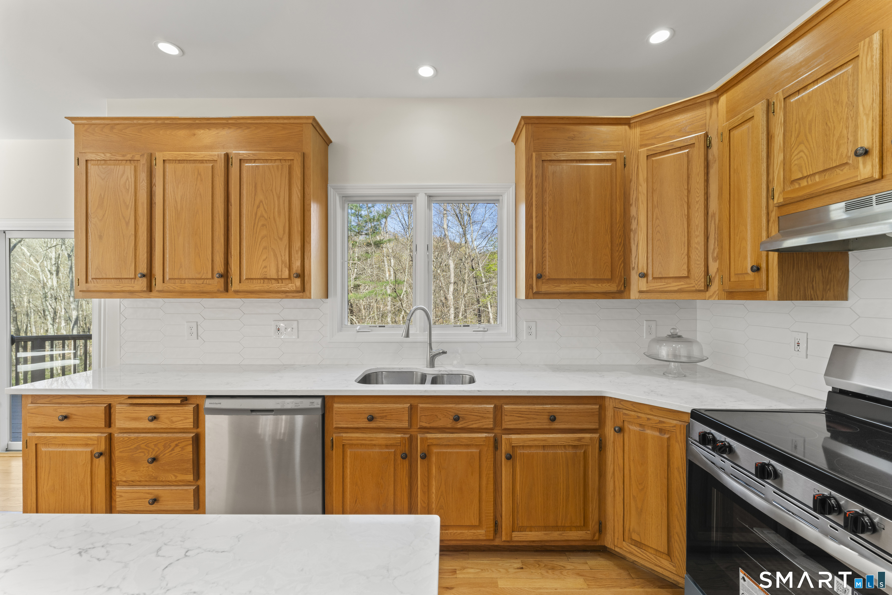 5 Beagle Trail Newtown, CT 06482 - Photo 16 of 40 a kitchen with stainless steel appliances granite countertop a sink stove and cabinets