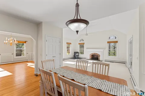 a view of a livingroom with furniture wooden floor windows and a chandelier