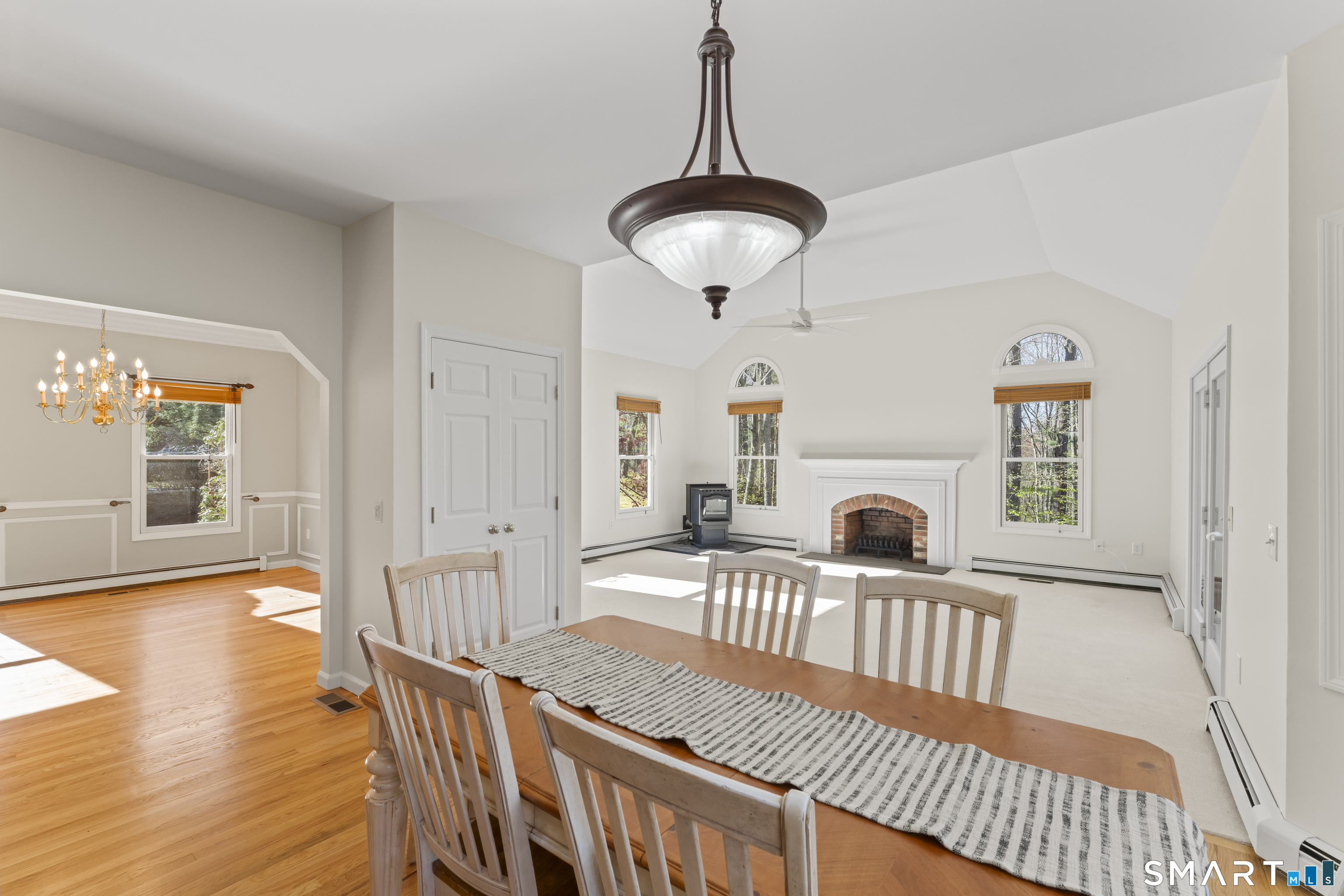 5 Beagle Trail Newtown, CT 06482 - Photo 17 of 40 a view of a livingroom with furniture wooden floor windows and a chandelier