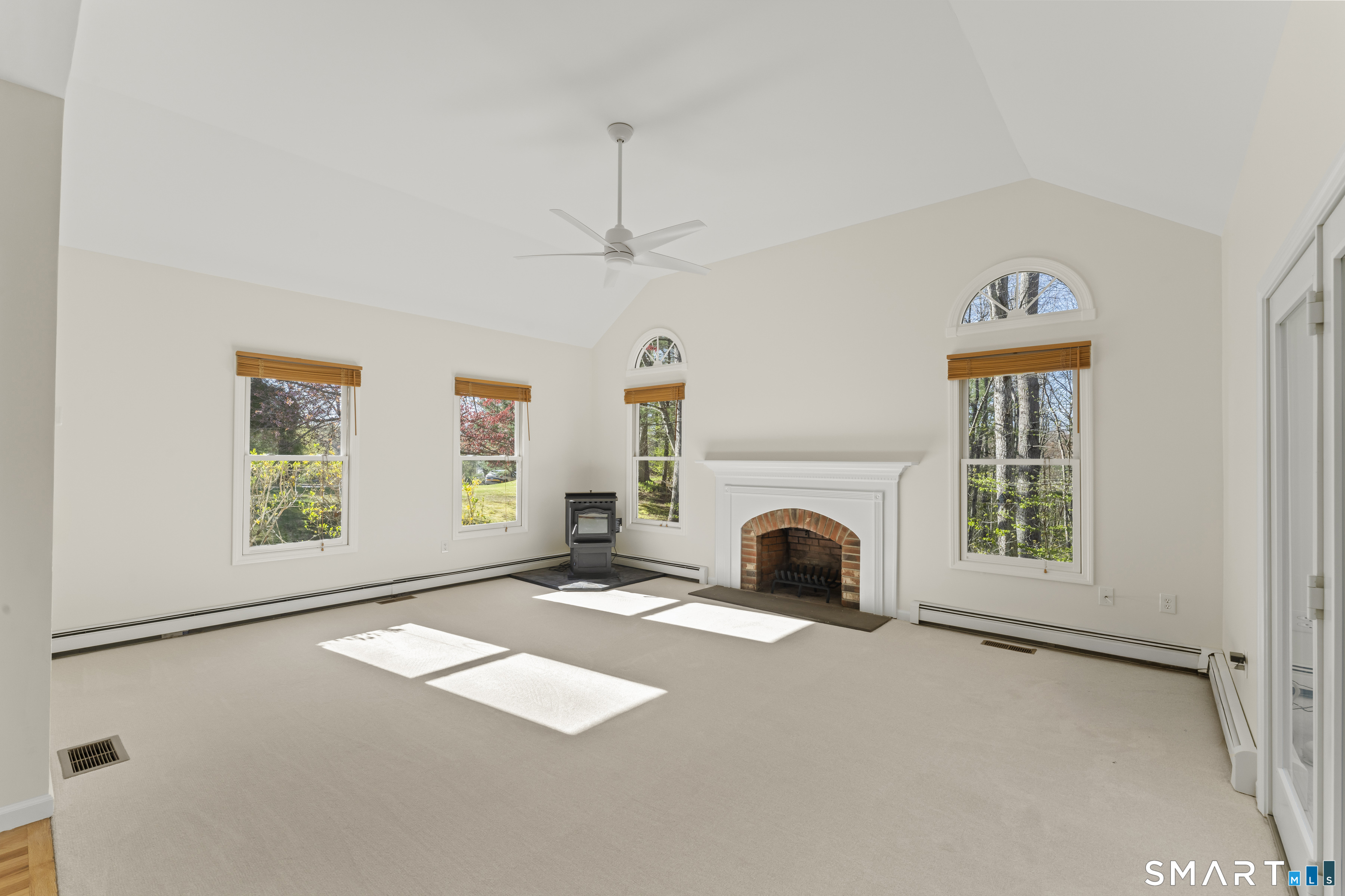 5 Beagle Trail Newtown, CT 06482 - Photo 18 of 40 a view of a livingroom with a fireplace and window