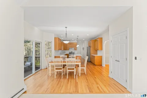 a view of a dining room with furniture wooden floor and chandelier