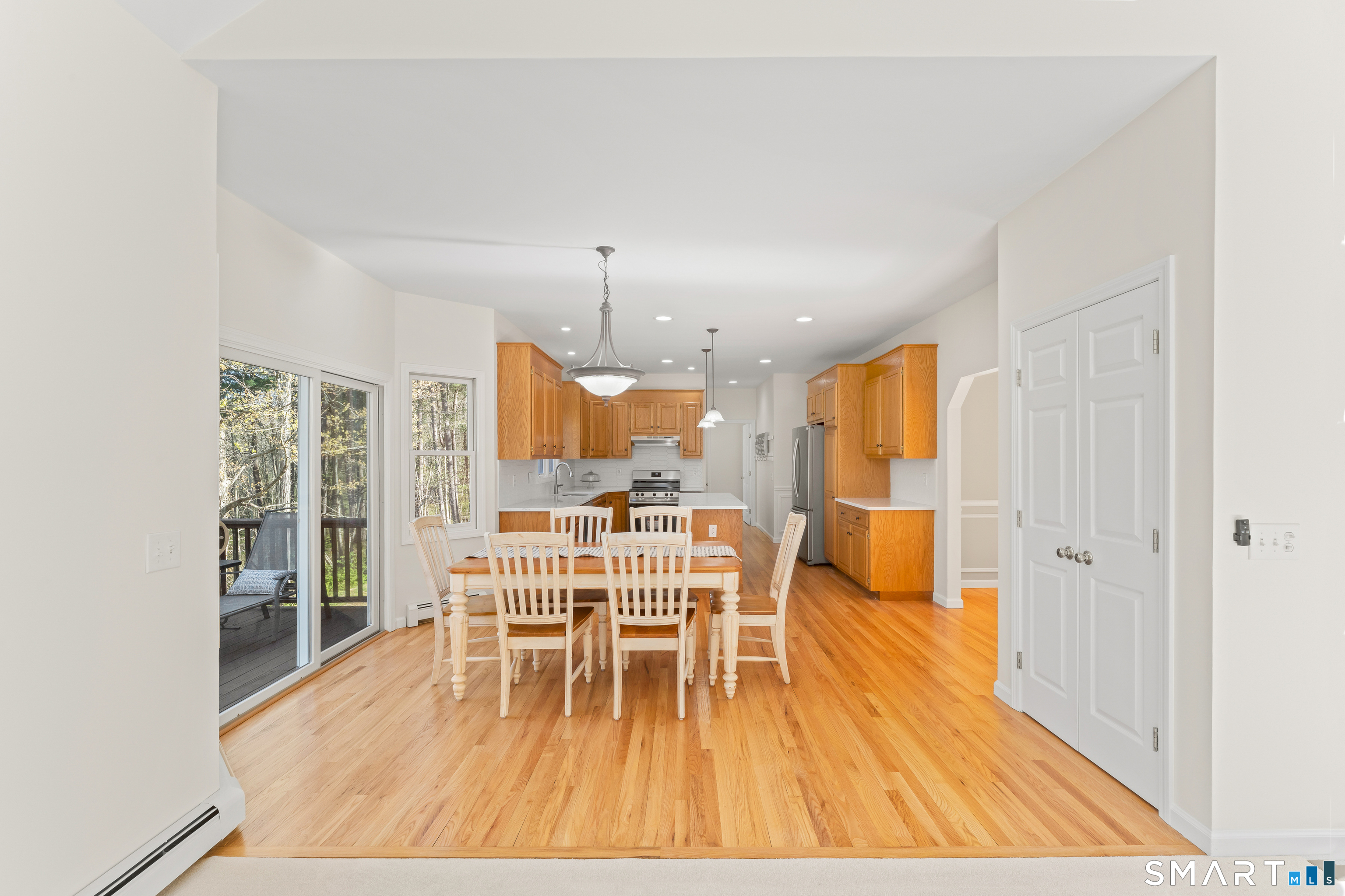 5 Beagle Trail Newtown, CT 06482 - Photo 20 of 40 a view of a dining room with furniture wooden floor and chandelier