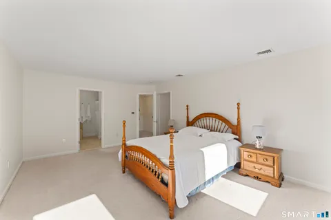 a bed room with a bed and a lamp