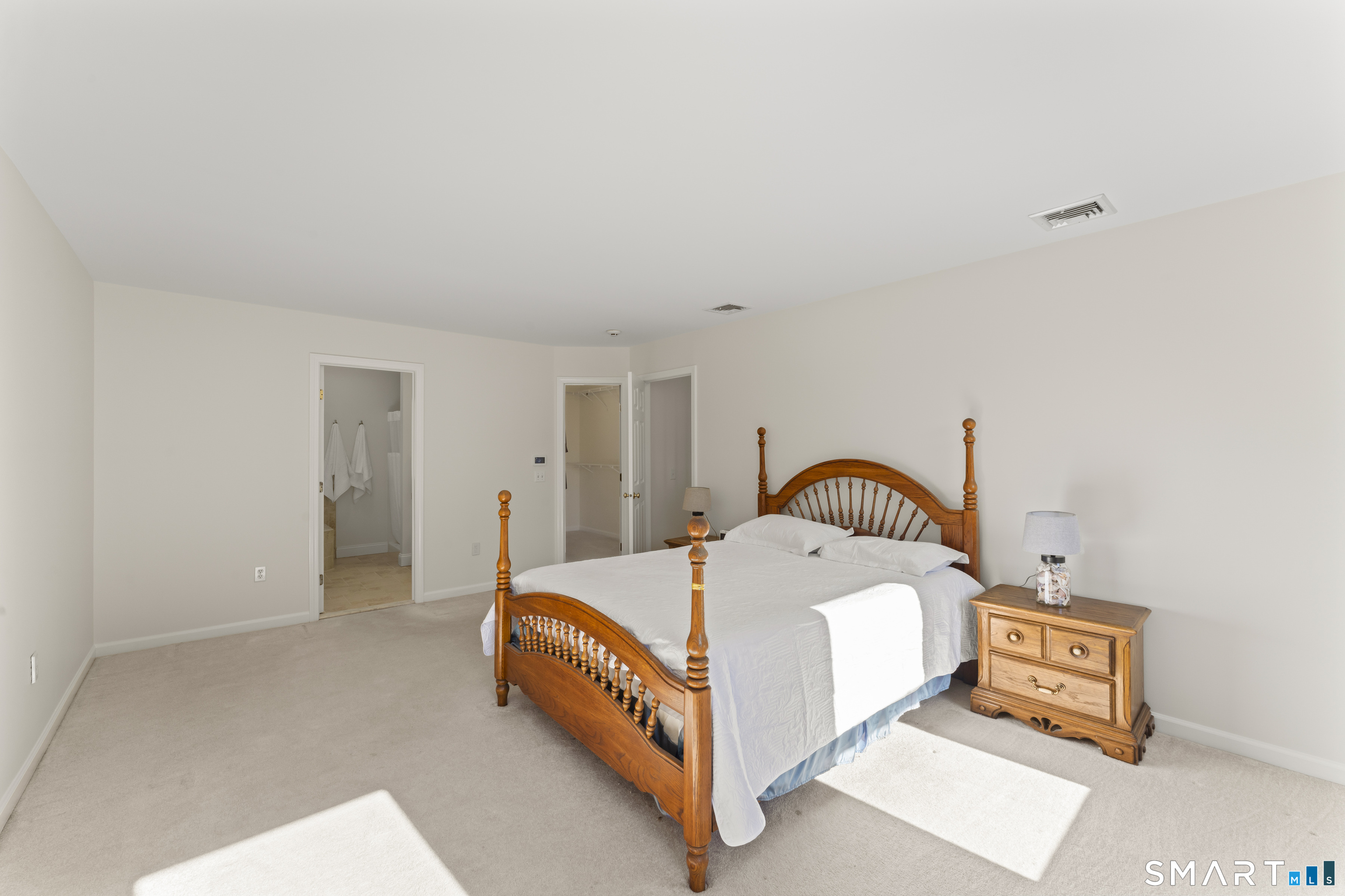 5 Beagle Trail Newtown, CT 06482 - Photo 28 of 40 a bed room with a bed and a lamp